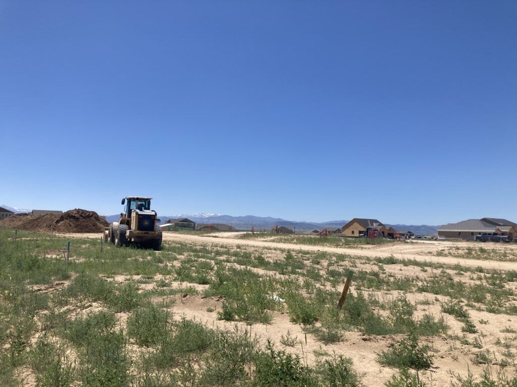 An earth-mover and a blue sky frame homes by Trumark Colorado