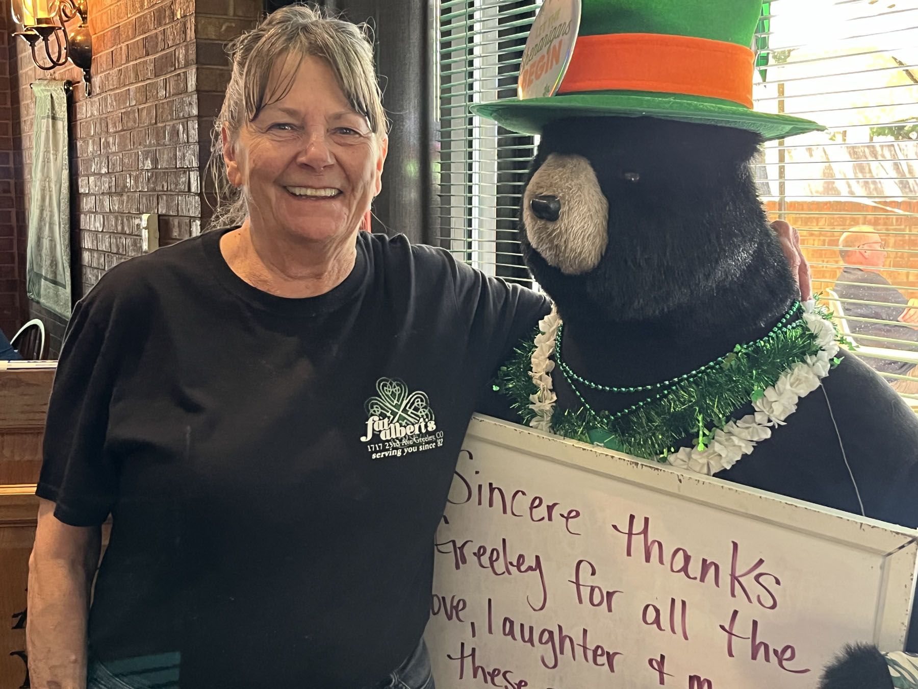 Sue Albert stands with her greeting bear in Fat Albert's restaurant in Greeley.