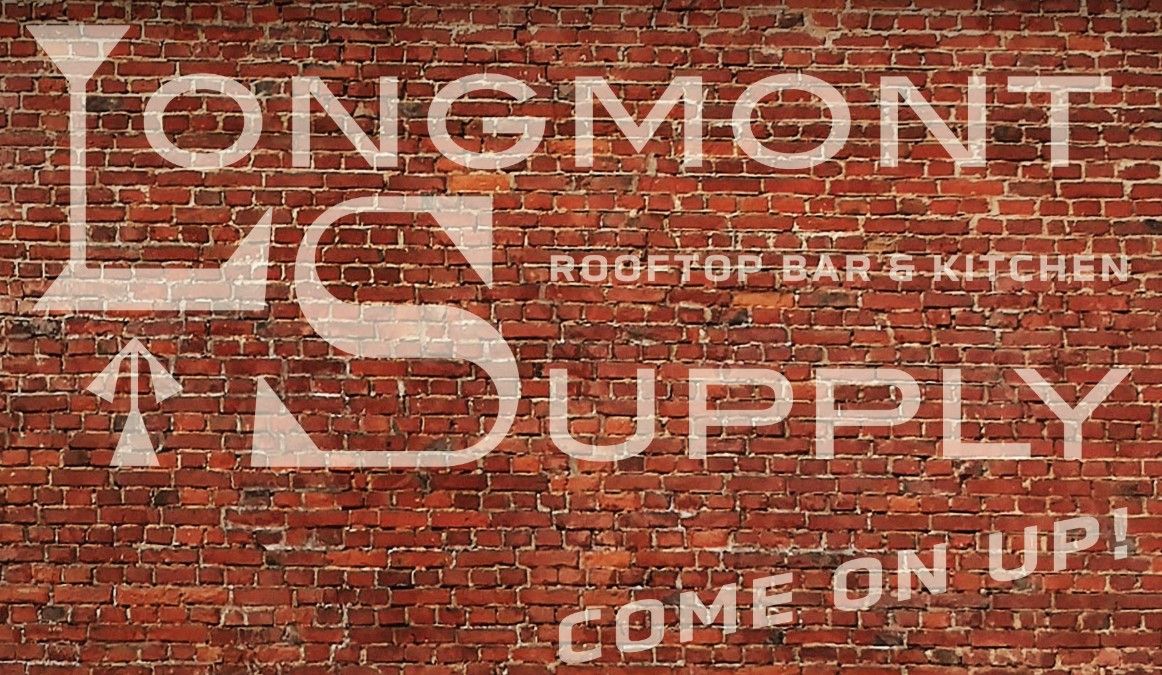 Longmont Supply Co. on a backgropd of brick wall