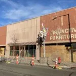 Greeley Furniture building with cones and a fence blacking people form entry