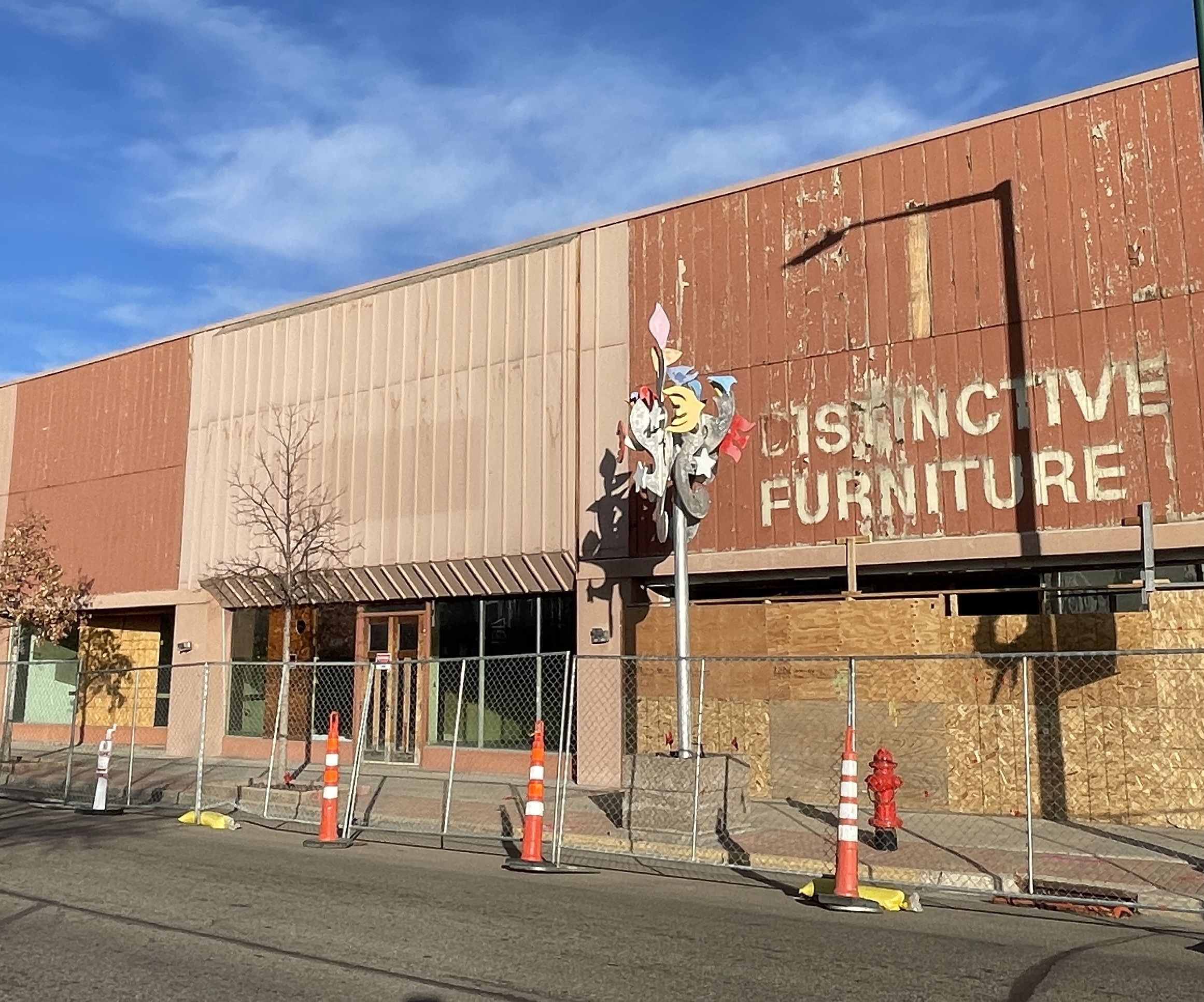 Greeley Furniture building with cones and a fence blacking people form entry