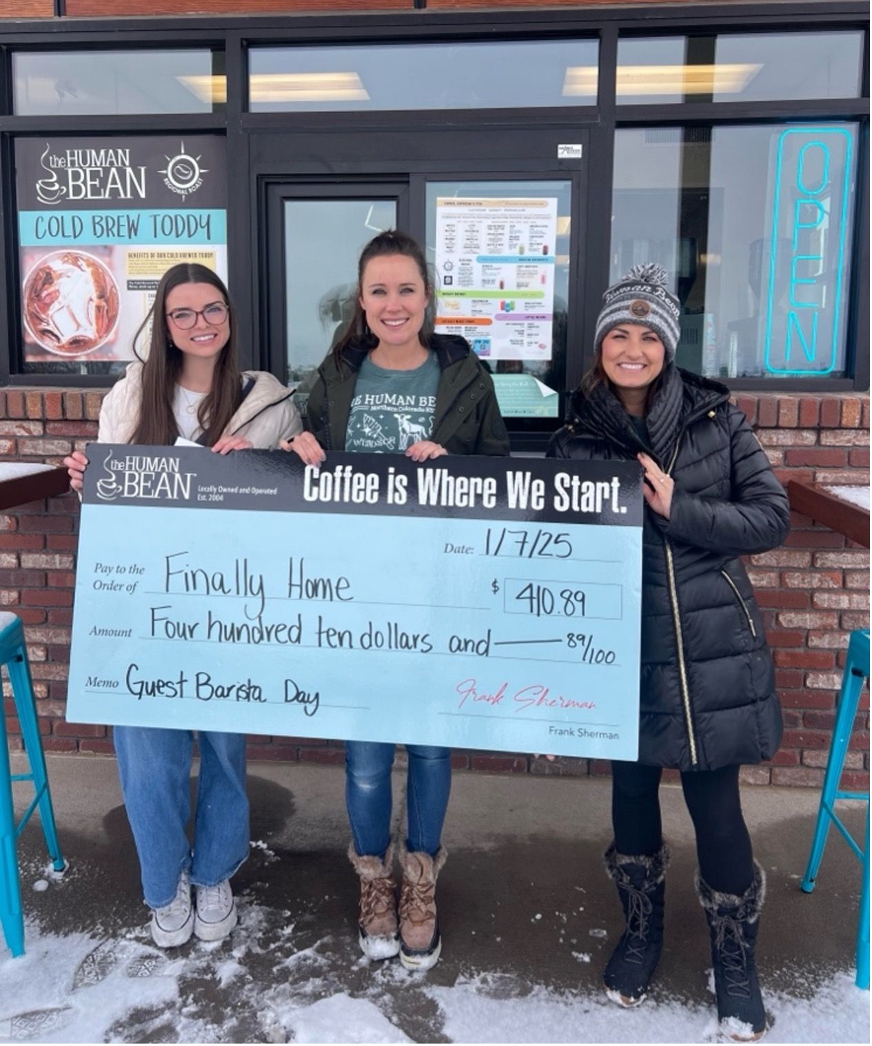 women holding large check