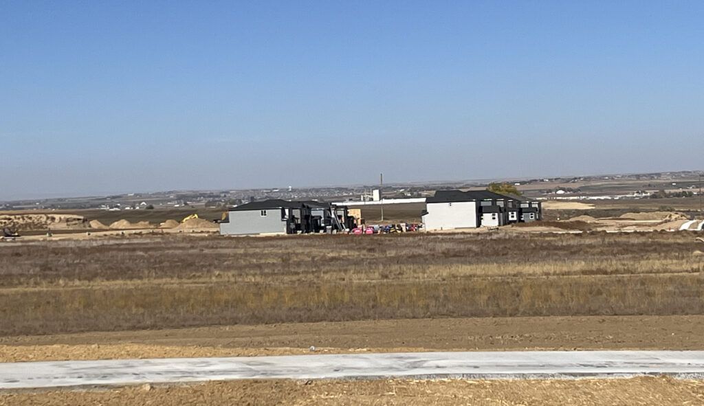 A row of homes built in the middle of a field