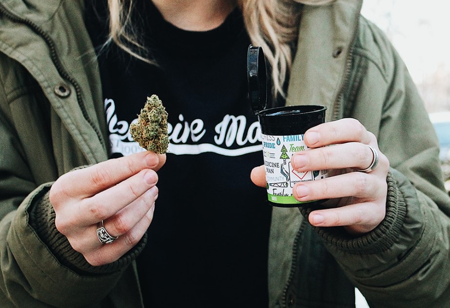 A person holding marijuana.
