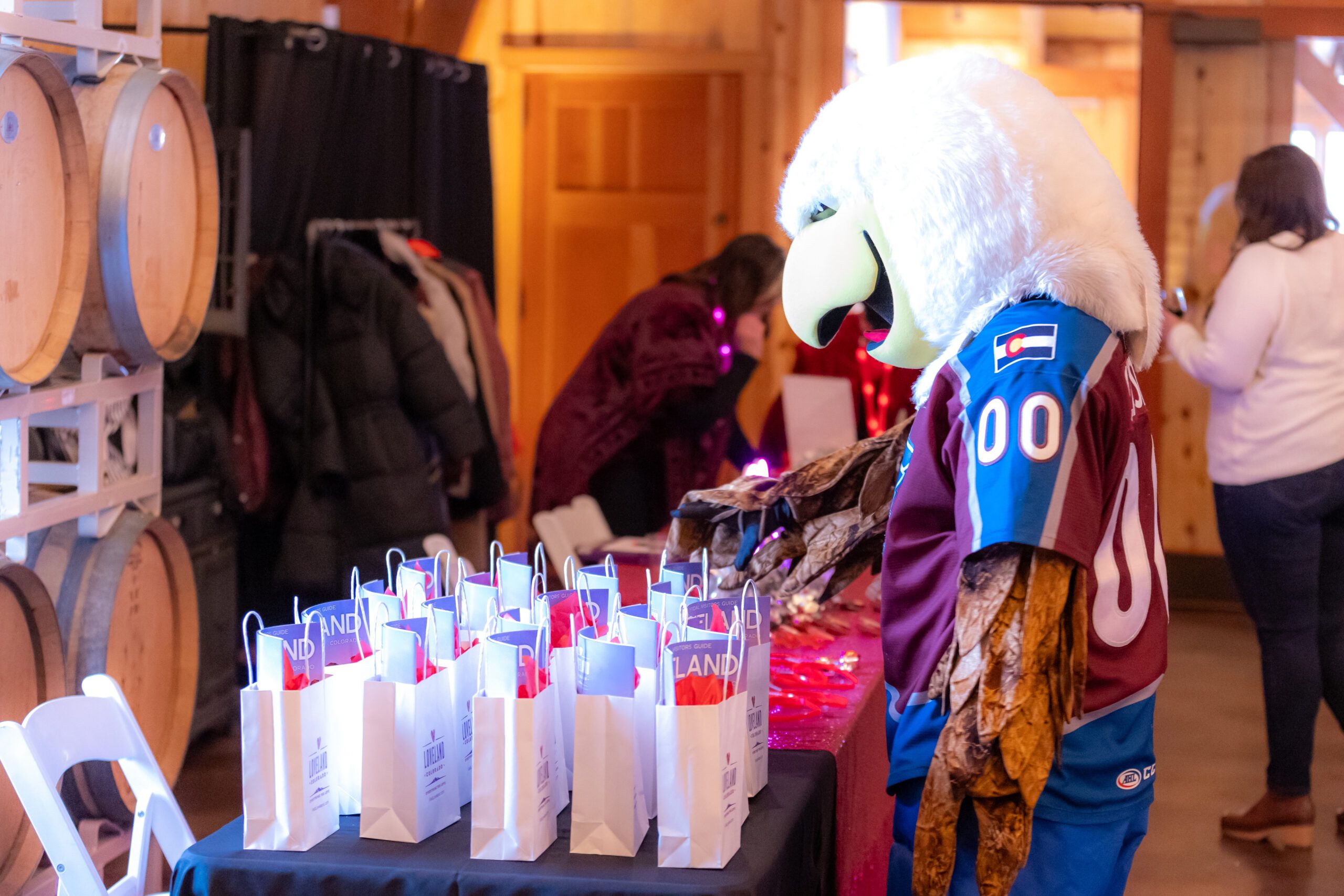 Colorado Eagles Mascot looks at table full of bags