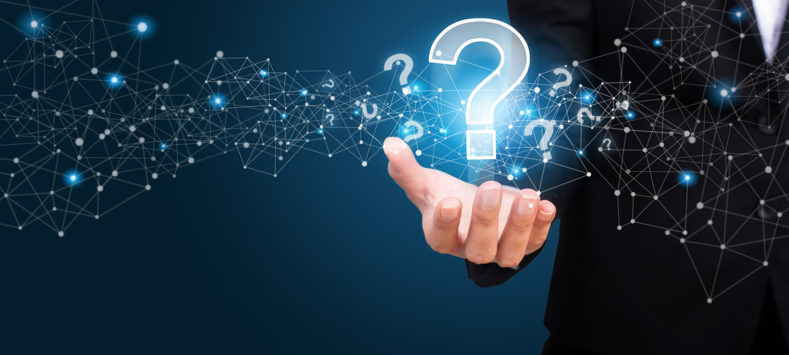 iStock image of woman holding question marks.