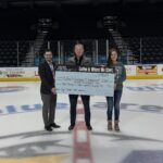 Human Bean presenting donation.