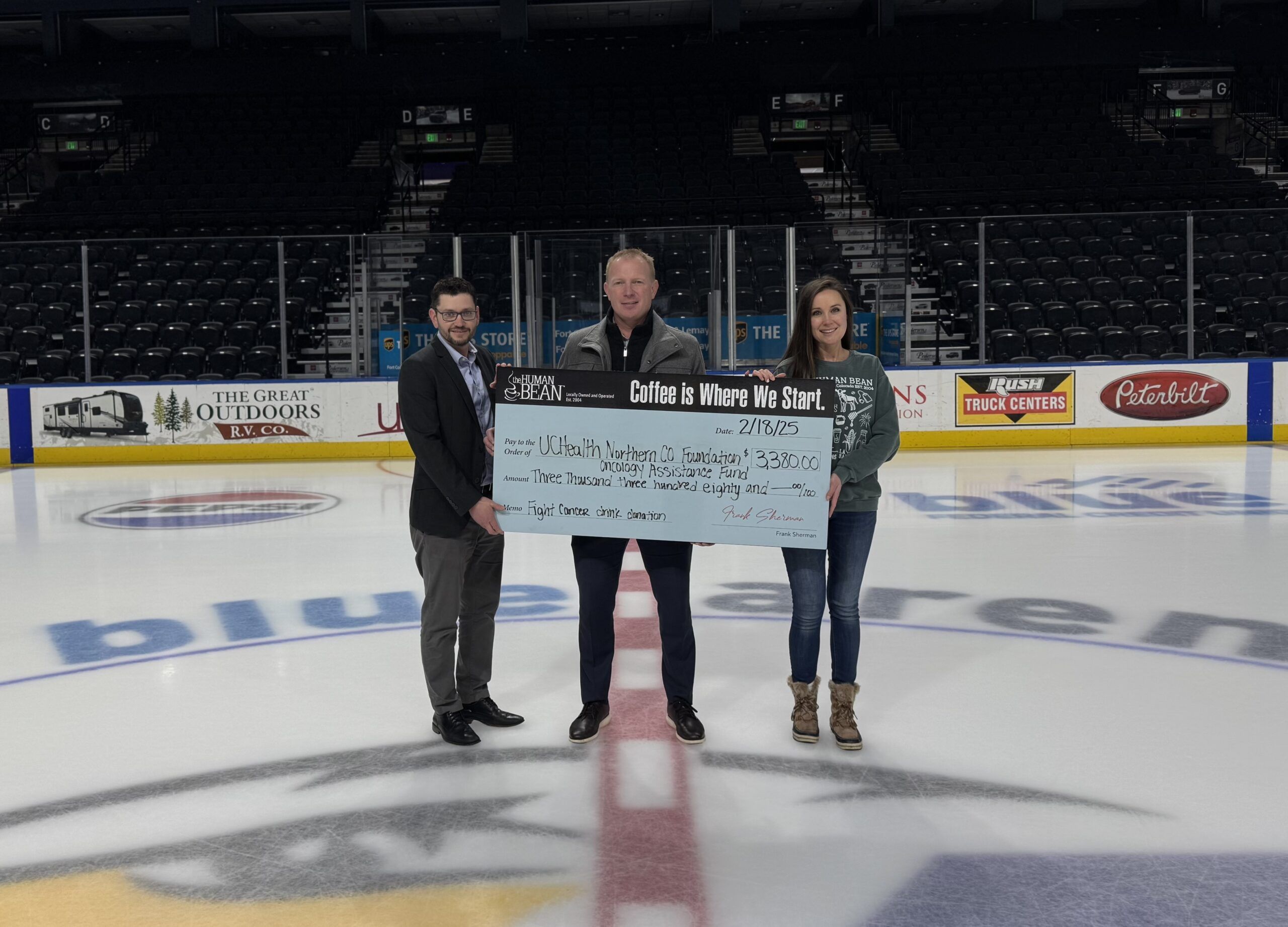 Human Bean presenting donation.