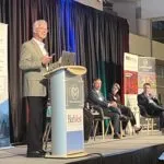 Darin Atteberry at podium at Northern Colorado Real Estate Summit.