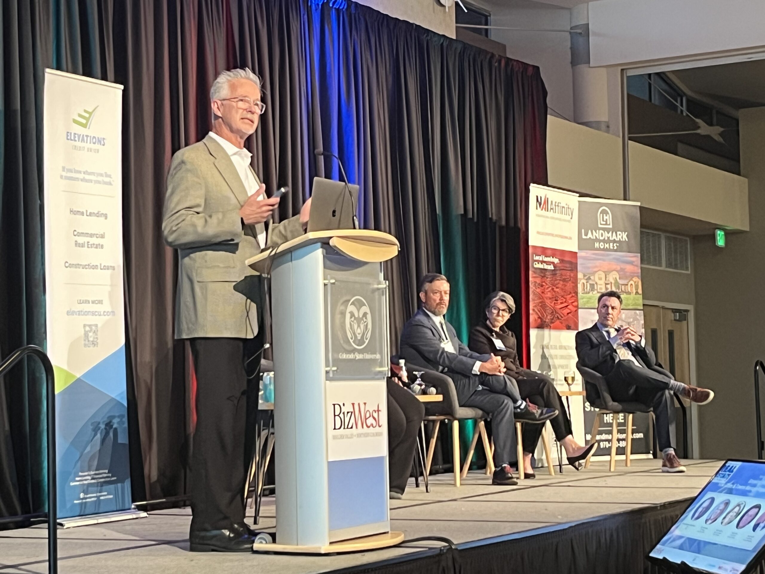 Darin Atteberry at podium at Northern Colorado Real Estate Summit.
