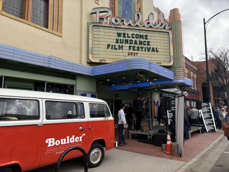 A film crew, complete with a parade of classic cars, working near the Boulder Theater on Friday, March 28, 2025.
