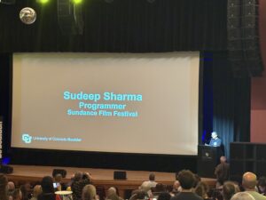 Sundance Film Festival programmer Sudeep Sharma speaking at CU Night in Downtown Boulder. Lucas High/BizWest.