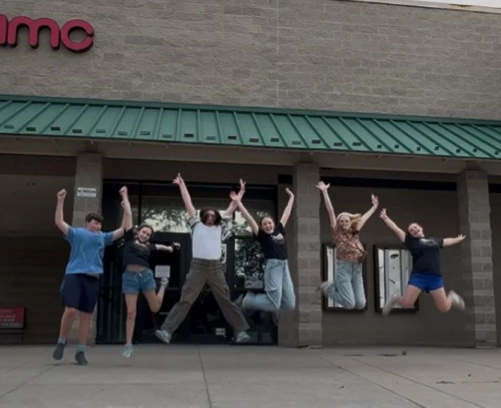 Debut Theatre Company troupe members pose in front of the shuttered AMC Cinema Saver 6 in midtown Fort Collins, where the company wants to build a performing arts center.