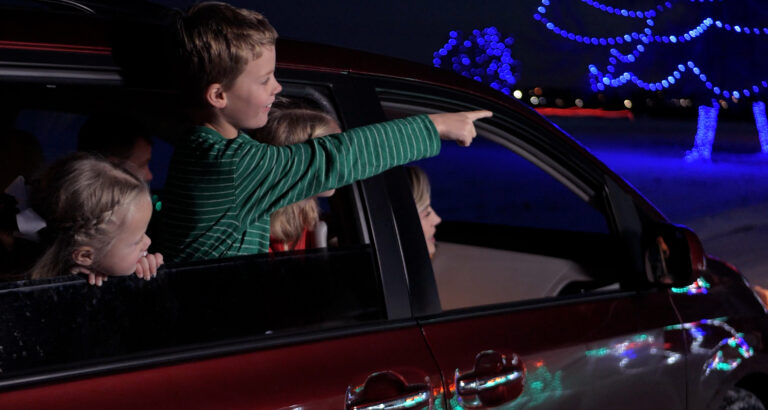 Children gaze at a display while riding through a previous NoCo Winter Wonderland.