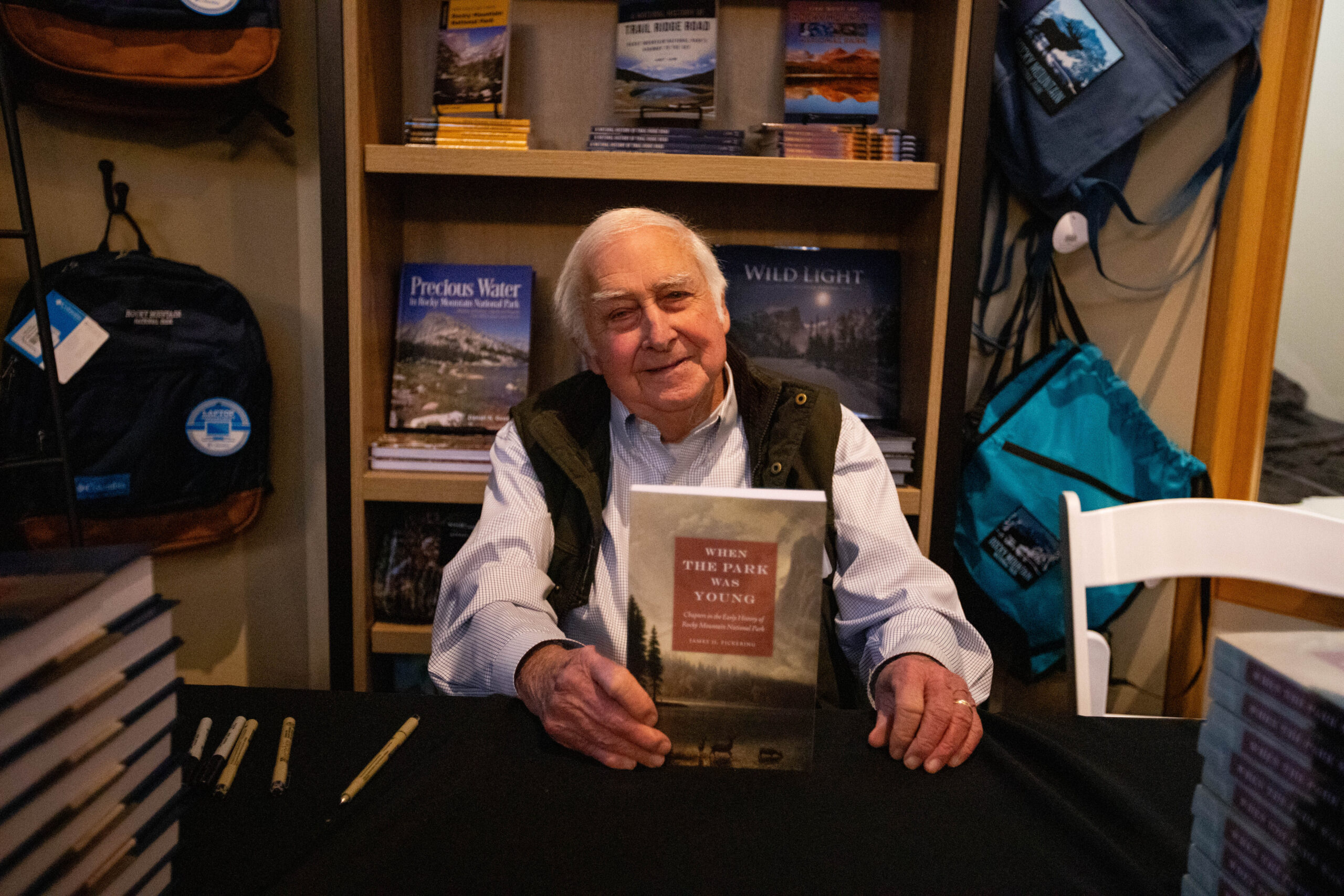 James Pickering signs copies of his new book at a gathering for Rocky Mountain Conservancy members.